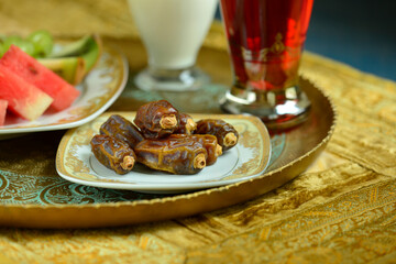 Sweet dates are served with fresh fruits and home made beverage or Sharbat in an antique tray. Islamic traditional way of serving food snacks to the guest.