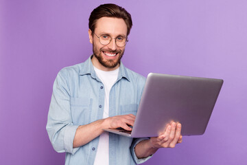 Photo of happy cheerful smiling handsome businessman in glasses working in laptop isolated pm...