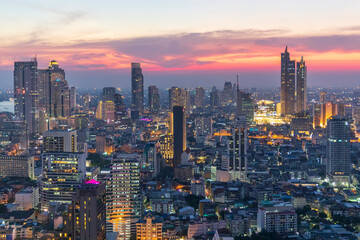 Fototapeta na wymiar Sunset panorama aerial view in the middle of Bangkok cityscape skyline .Night scene before sunrise , Thailand.