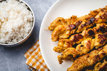 Famous Asian Chicken Dish- Chicken Satay with Peanut Sauce and rice bowl- top view