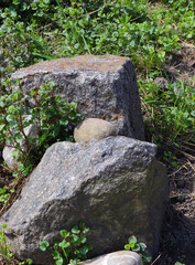 Naturally occurring rounded stone on the boulder. 