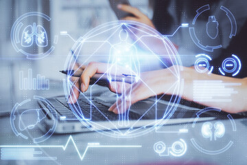 Double exposure of woman hands typing on computer and general theme hologram drawing. Education concept.