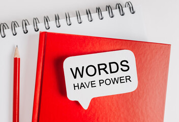 Text Words Have Power on a white sticker on red notepad with office stationery background. Flat lay on business, finance and development concept