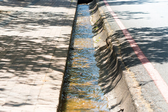 stormwater drain, furrow, channel for water in a road as urban water management concept