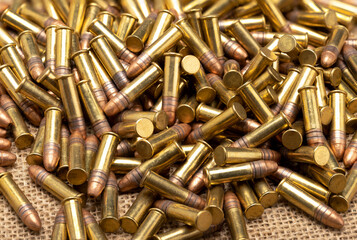 Close up of .22 ammunition on burlap background , .22 LR bullets