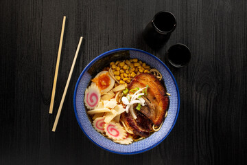 Japanese miso ramen soup on dark background viewed from above. Japanese noodles.