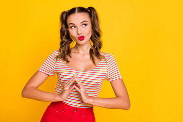 Portrait of attractive cunning cheerful girl planning strategy thinking isolated over bright yellow...