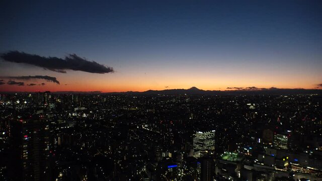 TOKYO, JAPAN : Aerial high angle sunset CITYSCAPE of TOKYO. View of buildings around Shinjuku and Nakano ward. Japanese city life, business and urban metropolis concept. Real time fixed shot.