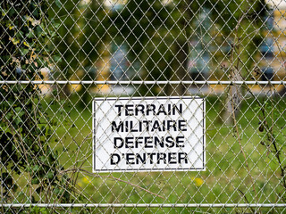 Une affiche terrain militaire défense d'entrer sur une clôture