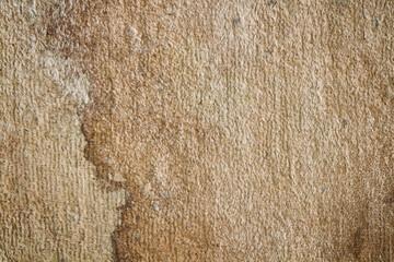 The texture of old carpet doormat with stain