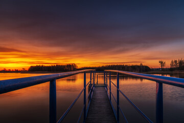 Naklejka na ściany i meble a beautiful sunrise on the lake shore in eastern Poland and a wonderful sky full of colors