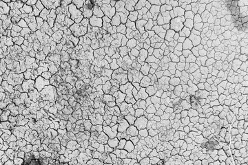 Mudflat cracked desert barren surface for natural background, layer, wallpaper, photo effect. Black and White Monochrome image of drought effects of global warming