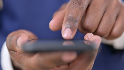 Close Up of African Businessman Using Smartphone, Text Messaging