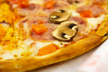 pizza with mushrooms cheese tomatoes sausage and shrimps close-up in a carton box, crispy crust of bread, appetizing dish, delicious sandwich, melted cheese, nutritious product, pizza dough, juicy pie