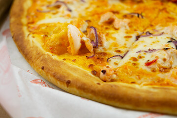 pizza with mushrooms cheese tomatoes sausage and shrimps close-up in a carton box, crispy crust of bread, appetizing dish, delicious sandwich, melted cheese, nutritious product, pizza dough, juicy pie