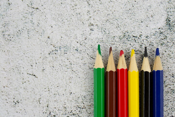 colored pencils on a light background, pens on a marble table, writing object lies, felt-tip pens for drawing, children's marker for creativity, ink for paintings