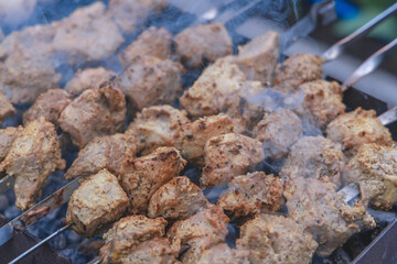 Cooking meat on coals outside. selective focus. Grilled meat background. Grilled shish kebab on the gri