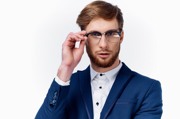 portrait of a handsome man in glasses and in a classic suit on a light background