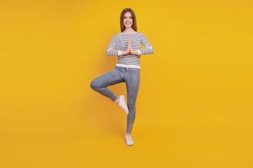 Fototapeta na wymiar Portrait of funny young woman girl posing meditate relax palms together
