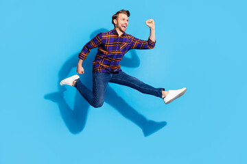 Fototapeta na wymiar Full body profile side photo of charming funky young man jump up run sale isolated on pastel blue color background