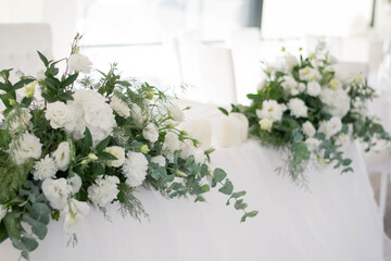 Main table at a wedding reception with beautiful fresh flowers