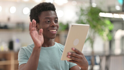 Young African Man doing Video Chat via Tablet