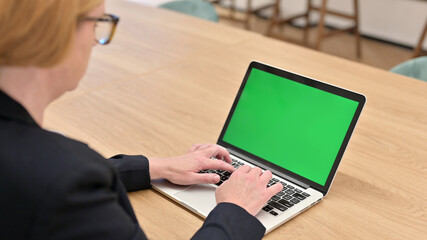 Old Businesswoman using Laptop with Chroma Screen