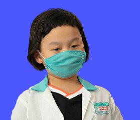 asia kid doctor with surgical mask look down isolated background portrait