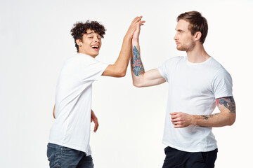 two friends in t-shirts holding hands emotions positive joy