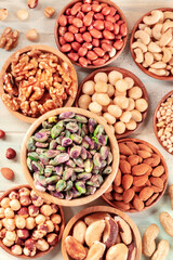 Nuts, many different types of, top shot on a teal wooden background