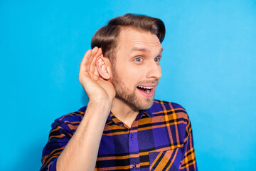 Close-up portrait of attractive cheerful funky sly man listening you over hear isolated over bright...