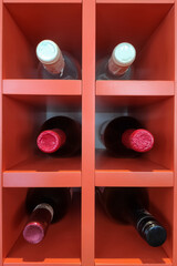 bottles of alcohol are on the shelf under each other. vertical photo
