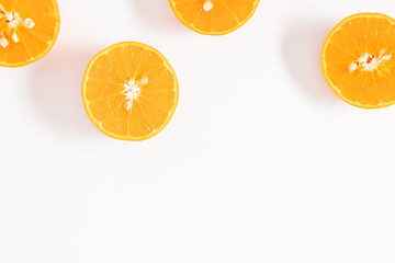 Half of orange on white background. Flat lay, top view, copy space