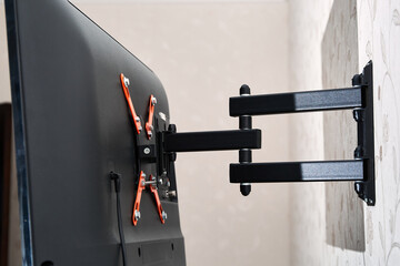Swivel TV bracket LED display. Back view. X-shaped red fasteners. Black color. Multiplanar. Hangs...