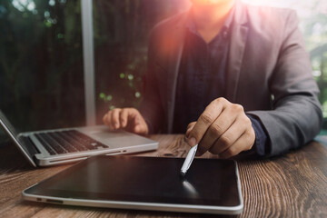 Businessman holding tablet and checking analyzing sales data growth graph chart and stock market on global networking. Business strategy, planning and digital marketing on blue background.