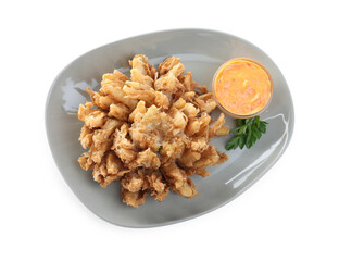 Plate with fried blooming onion and sauce isolated on white, top view