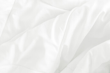 Close up top view of white bedding sheet and wrinkle messy blanket in bedroom after wake up in the morning.