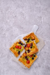 Puff pastry pie with vegetables and sausages