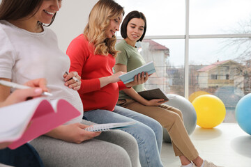 Group of pregnant women at courses for expectant mothers indoors
