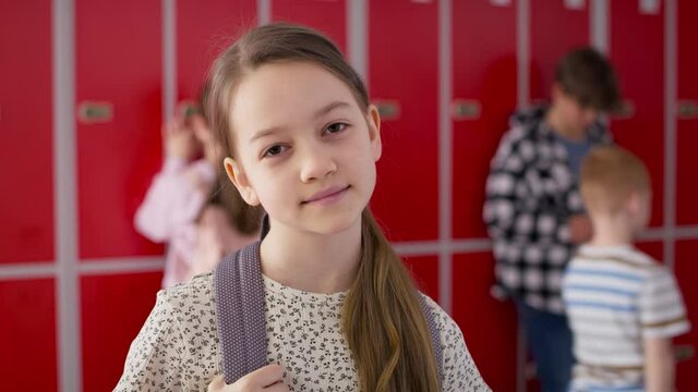 Video portrait of smiling girl standing at school. Shot with RED helium camera in 8K.