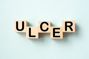The word ulcer is written on wooben cubes. Medical concept