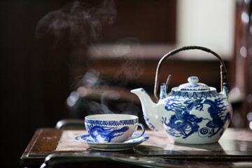 Old style Chinese tea mugs, Chinese hot tea set on an old Chinese wooden table.