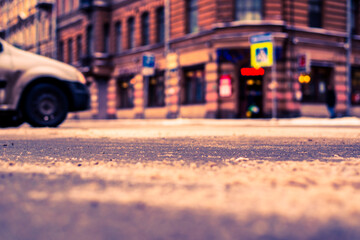 Snowy winter in the big city, the car rides. Close up view from the asphalt level