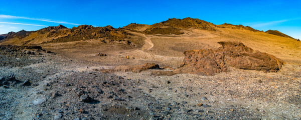 Panoramic view over Icelandic landscape of colorful volcanic caldera Askja, in the middle of volcanic desert in Highlands, with red, turquoise volcano soil and blue sky, Iceland