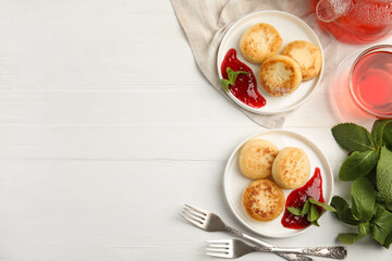 Delicious cottage cheese pancakes with jam and mint on white wooden table, flat lay. Space for text