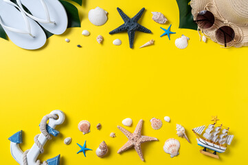 Summer beach design concept with shells, hat, slipper on yellow background.