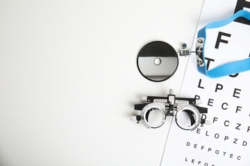 Different ophthalmologist tools on white table, flat lay. Space for text - obrazy, fototapety, plakaty