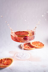 Rose champagne splashing on a light background