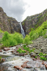 Creek with rushing water and waterfalls in a canyon