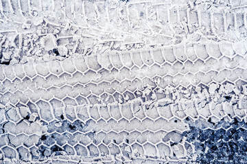 Trace of car tires in the snow. Close up view from above